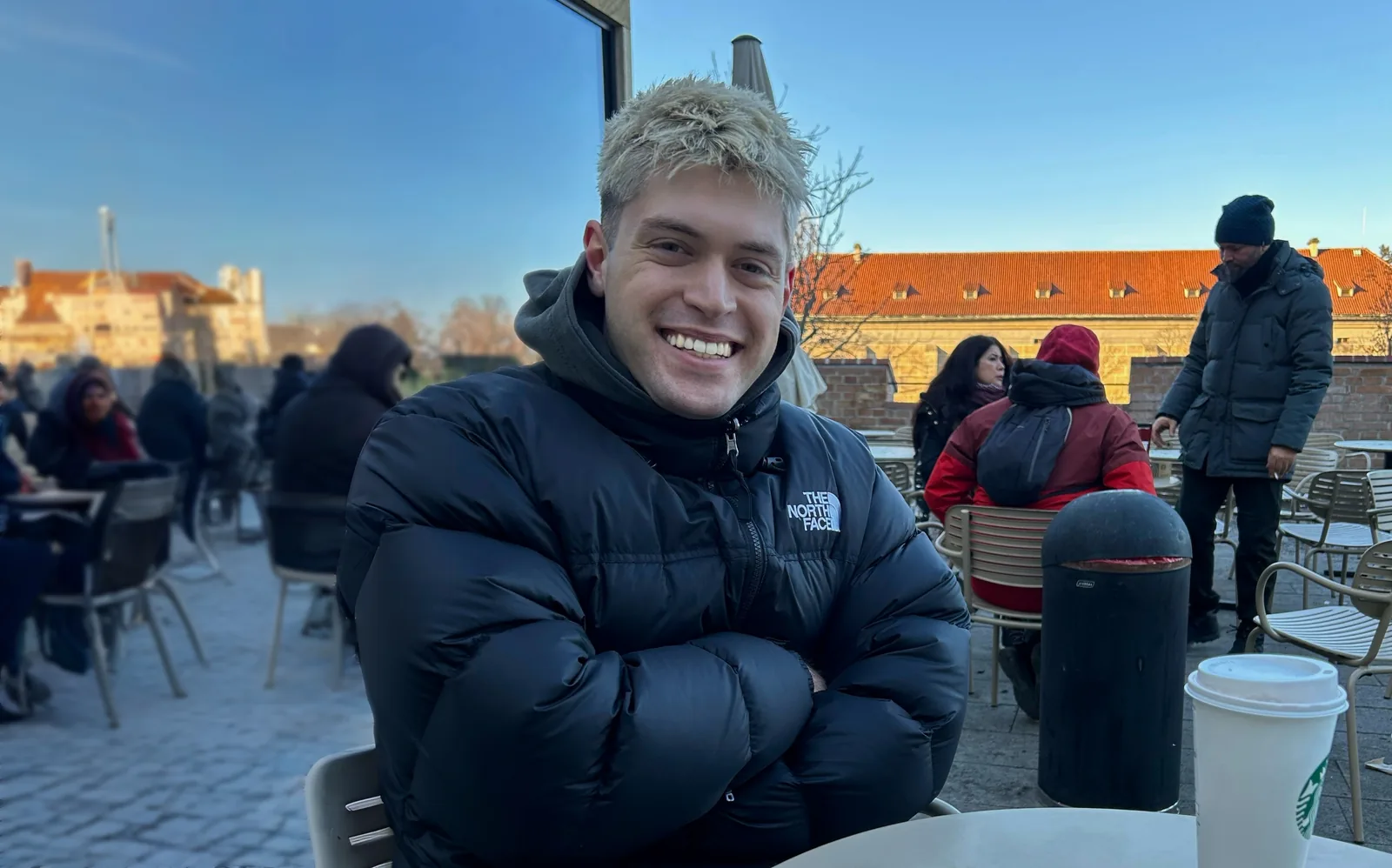 Valentino Ivanovski smiling at an outdoor café